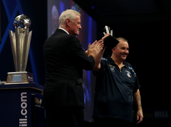 LONDON, ENGLAND - JANUARY 04: Phil Taylor of England recieves his runners up trophy from the chairman of the PDC Barry Hearn after losing out to Gary Anderson of Scotland in the final of the 2015 Will ...