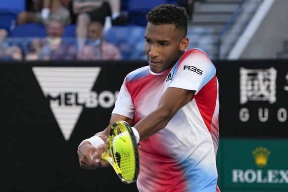 Felix Auger-Aliassime of Canada plays a backhand return to Alejandro Davidovich Fokina of Spain during their second round match at the Australian Open tennis championships in Melbourne, Australia, Thu ...