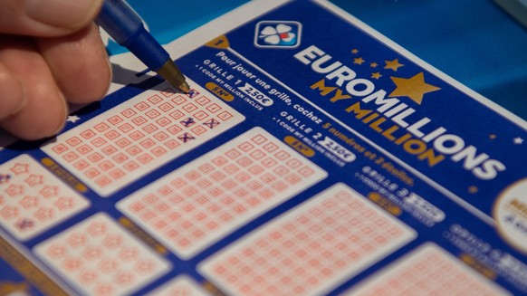 epa08862321 A person plays a EuroMillions grid in Bordeaux, France, 04 December 2020. The jackpot for this draw will reach 200 million euro. Before 2020, the jackpot was capped at 190 million euros. E ...