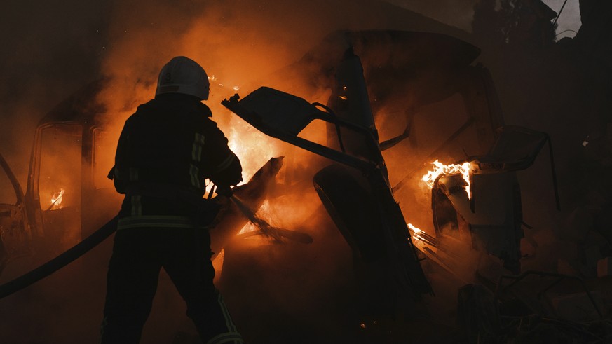 Firefighters work at the site of fire after Russian shelling in Mykolaiv, Ukraine, Saturday, June 18, 2022. (AP Photo/George Ivanchenko)