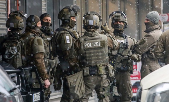 epa10359030 Members of a special police task force unit secure the area near a shopping center in Dresden, Germany, 10 December 2022. Police announced on its social media that a hostage situation in t ...