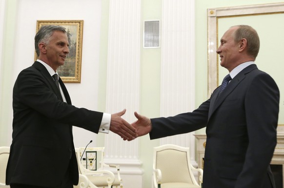 epa04195184 Russian President Vladimir Putin (R) and Swiss President and OSCE Chairman Didier Burkhalter (L) shake hands during a meeting at the Kremlin in Moscow, Russia, 07 May 2014. Burkhalter, who ...