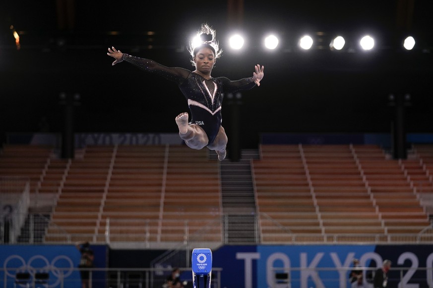 Simone Biles, of the United State, trains on the beam during an artistic gymnastics practice session at the 2020 Summer Olympics, Thursday, July 22, 2021, in Tokyo, Japan. (AP Photo/Gregory Bull)