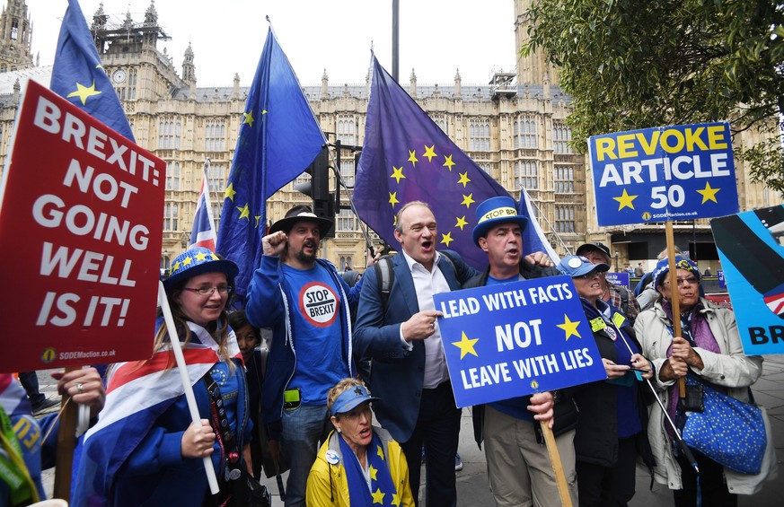 epa07830293 Anti Brexit protesters stand outside the Houses of Parliament with Liberal Party Member of Parliament, Ed Davey (C) in London, Britain, 09 September 2019. Britain&#039;s Prime Minister Bor ...