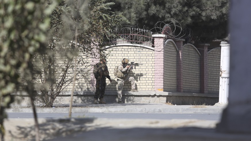 Afghan security personnel take a position near the Shamshad Television after an attack in Kabul, Afghanistan, Tuesday, Nov. 7, 2017. Jan Agha, a police officer, says a gun man attacked on the local TV ...
