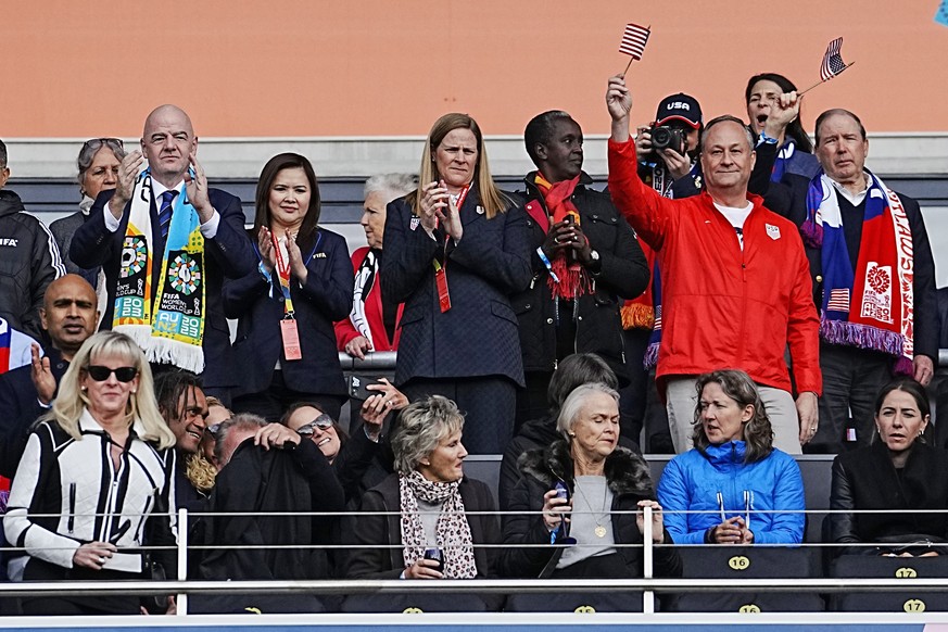 Second gentleman Doug Emhoff, second from right, waves a flag before the Women&#039;s World Cup Group E soccer match between the United States and Vietnam at Eden Park in Auckland, New Zealand, Saturd ...