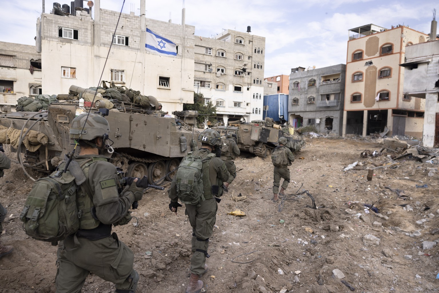 FILE - Israeli soldiers walk in Gaza City&#039;s Shijaiyah neighborhood on Dec. 8, 2023, as part of an operation to round up hundreds of Palestinians across the northern Gaza Strip and truck some to a ...