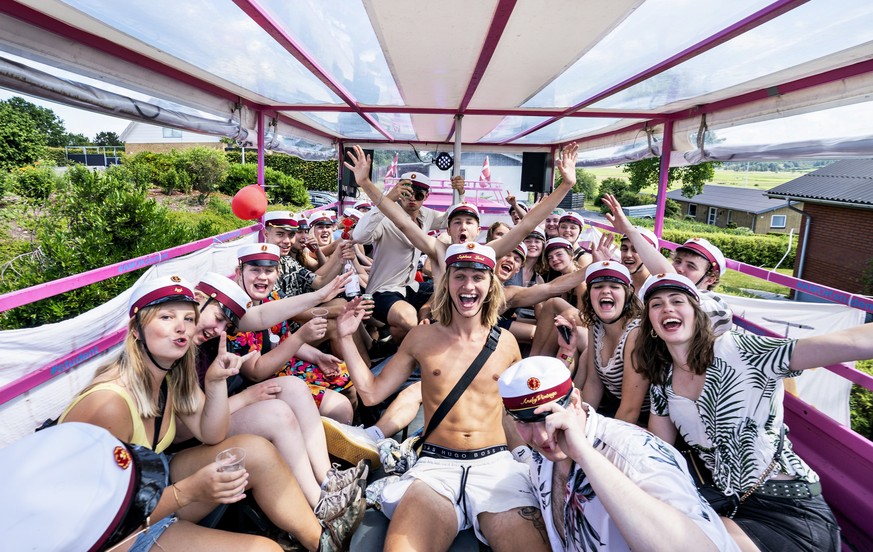 epa08508362 Danish high school students embark on the traditional wagon ride, where the home of each student is visited, after graduating from three-year high school in Viborg, Denmark, 25 June 2020.  ...