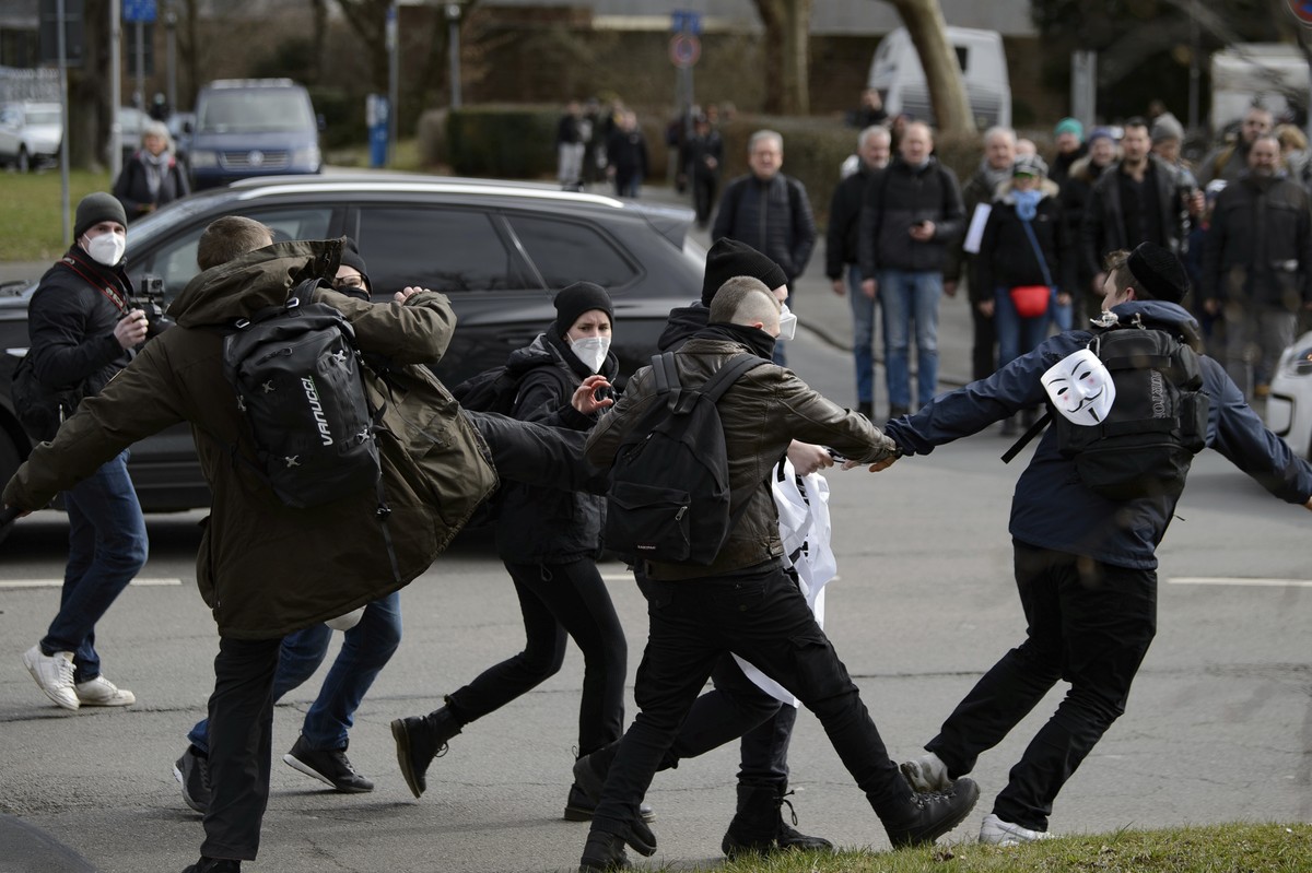Participants scuffle at a rally under the slogan "Free citizens Kassel - basic rights and democracy" in Kassel, Germany, Saturday, March 20, 2021. According to police, several thousand peopl ...