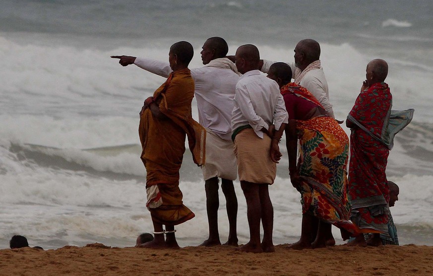 epa07542365 Indian people stand near the coastal line at Konark in Puri district on the eve of cyclone Fani&#039;s landfall in Odisha coast, India, 02 May 2019. According to news reports, the National ...