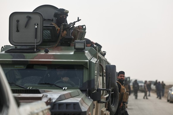 Syrian security forces gather before entering the town of al-Hassakeh to implement an agreement with the Kurdish-led Syrian Democratic Forces (SDF) to stabilize a ceasefire, in Wadi al-Raml, al-Hassak ...
