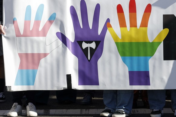 epa11034036 LGBTQI flags are seen during the demonstration in Madrid, Spain, on December 17, 2023, to fight for LGBTQI rights in Madrid, as the regional government wants to repeal a law passed in…