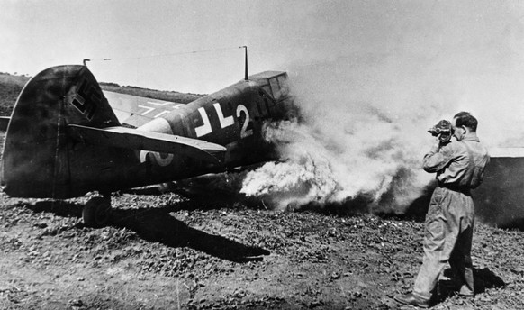 David Sholomovich, cameraman and major in the Soviet Air Force, films a burning Messerschmitt MB-4-1 shot down by Soviet flying ace captain Tarasov during World War II.