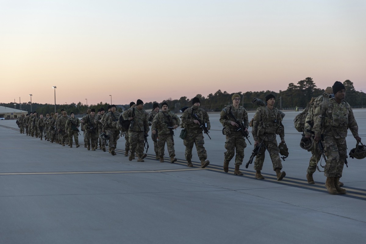Members of the 82nd Airborne Division of the U.S. Army walk on the tarmac at Pope Field ahead of deployment to Poland from Fort Bragg, N.C. on Monday, Feb. 14, 2022. They are among soldiers the Depart ...