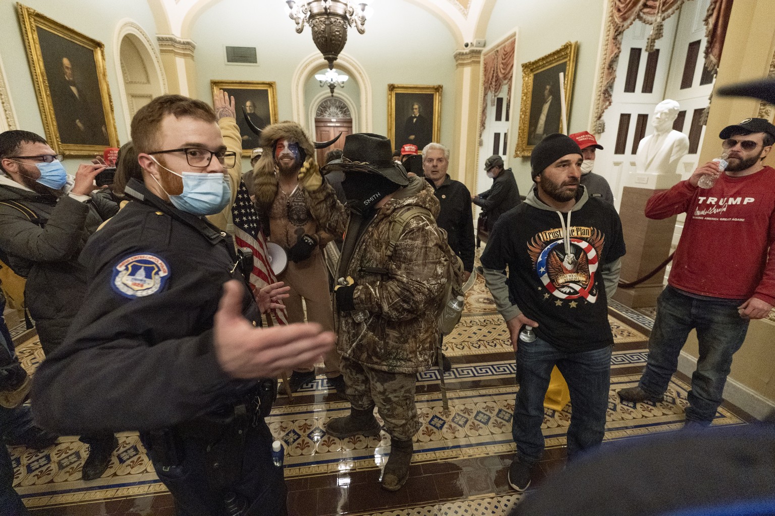 Supporter of President Donald Trump are confronted by Capitol Police officers outside the Senate Chamber at the Capitol, Wednesday, Jan. 6, 2021 in Washington. (AP Photo/Manuel Balce Ceneta)
