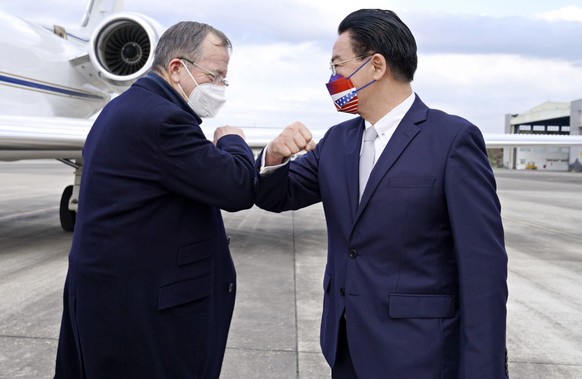 In this photo released by Taiwan&#039;s Ministry of Foreign Affairs, Taiwan&#039;s Foreign Minister Joseph Wu, right, greets former Chairman of the Joint Chiefs Adm. Mike Mullen as he arrives at Taipe ...