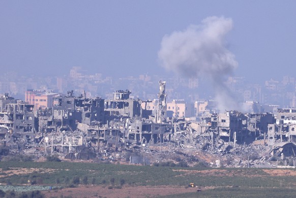 epa10960238 Smoke billows from buildings in the northern part of the Gaza Strip, as seen from southern Isrel, 06 November 2023. Over the last day, IDF forces struck over 450 Hamas targets in the Gaza  ...