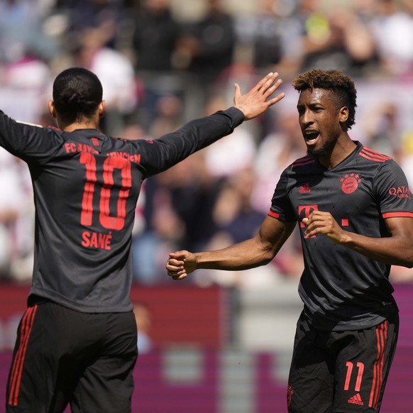 Bayern's Kingsley Coman, right, celebrates after scoring his side's opening goal besides team mate Leroy Sane during the German Bundesliga soccer match between 1. FC Cologne and FC Bayern Mu ...