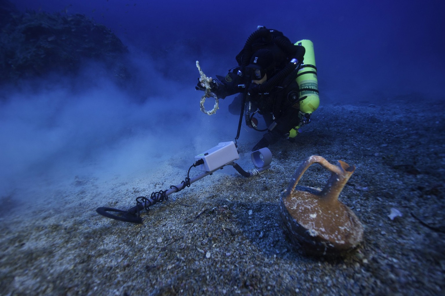 epa04438821 An undated photo released by the Greek Ministry of Culture on 09 October 2014 shows a diver approaching an almost intact pitcher, found at the site of underwater exploration near Antikythe ...