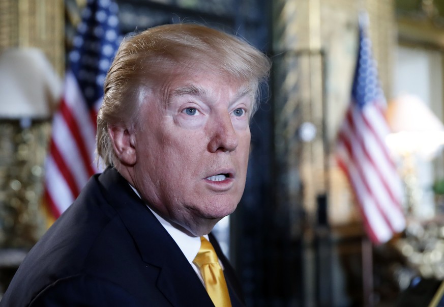 President Donald Trump speaks to the media before speaking with members of the armed forces via video conference at his private club, Mar-a-Lago, on Thanksgiving, Thursday, Nov. 23, 2017, in Palm Beac ...