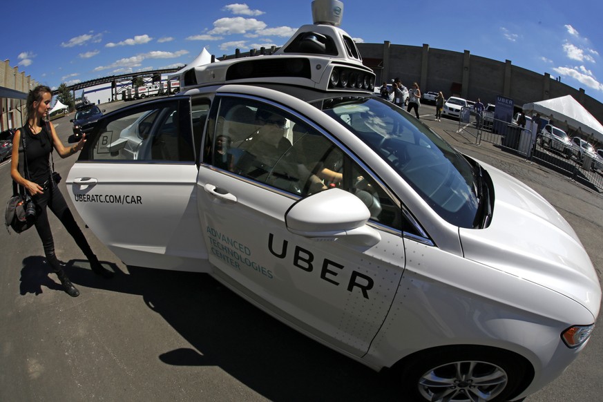 A journalist gets in a self driving Uber for a ride during a media preview at Uber&#039;s Advanced Technologies Center in Pittsburgh Monday, Sept. 12, 2016. Starting Wednesday morning, Sept. 14, 2016  ...