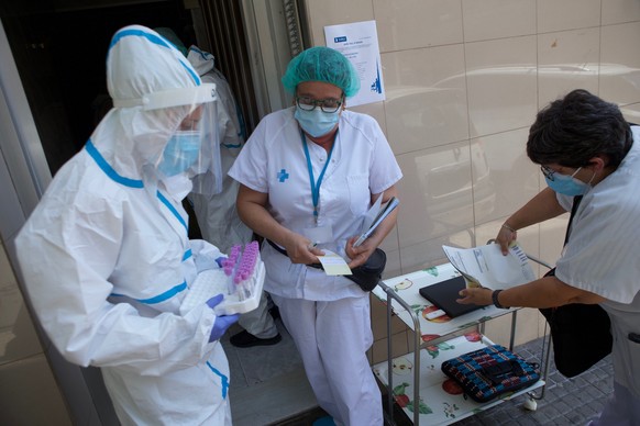 epa08585021 Health workers prepare to start the voluntary testing for covid-19 that is taking place in Ripollet, Barcelona, Spain, 05 August 2020. Some 9,000 people will get their swab samples collect ...