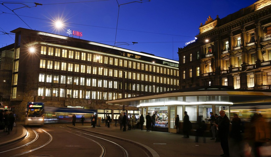 A tram drives past the building of Swiss banks UBS and Credit Suisse (R) at the Paradeplatz in Zurich January 15, 2015. The Swiss National Bank (SNB) shocked financial markets on Thursday by scrapping ...