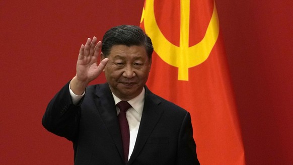 FILE - Chinese President Xi Jinping waves at an event to introduce new members of the Politburo Standing Committee at the Great Hall of the People in Beijing, Sunday, Oct. 23, 2022. President Joe Bide ...