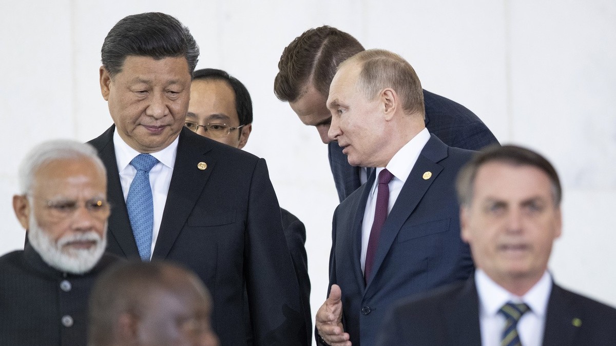 Le président russe Vladimir Poutine, en haut à droite, et le président chinois Xi Jinping, en haut à gauche, se parlent alors qu'eux-mêmes et d'autres dirigeants marchent pour assister aux é ...