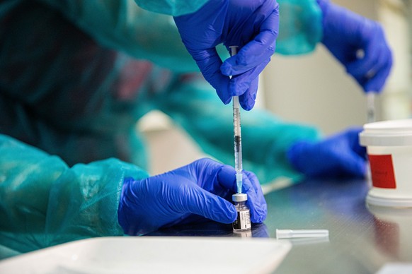 epa08905049 A health worker prepares a vaccine of the Pfizer-BioNTech against the COVID-19 at the faculty hospital in Nitra, Slovakia, 26 December 2020. Slovakia started with vaccination in the evenin ...