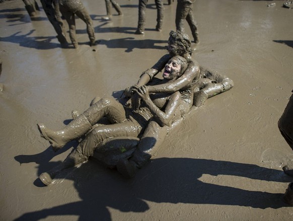 Festival visitors dance in the mud during OpenAir St. Gallen on Sunday 30 June 2013 in St. Gallen.  The OpenAir St.Gallen is one of the oldest open-air festivals in Switzerland.  It is near...