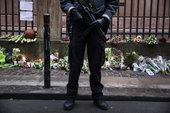 A policeman stands outside a synagogue where an attack took place, in Copenhagen, Sunday, Feb. 15, 2015. Danish police shot and killed a man early Sunday suspected of carrying out shooting attacks at  ...