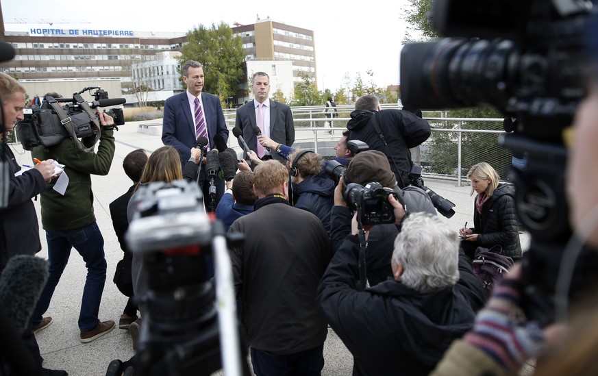Nathan Gill, UKIP spokesman for Wales, center left, and spokesman Hermann Kelly speak to journalists in front of the Hospital De Hautepierre in Strasbourg, eastern France, Friday, Oct. 7, 2016, where  ...