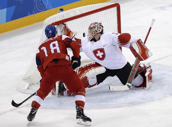 Dominik Kubalik (18), of the Czech Republic, shoots the puck past goalie Jonas Hiller (1), of Switzerland, for a goal during the third period of the preliminary round of the men&#039;s hockey game at  ...