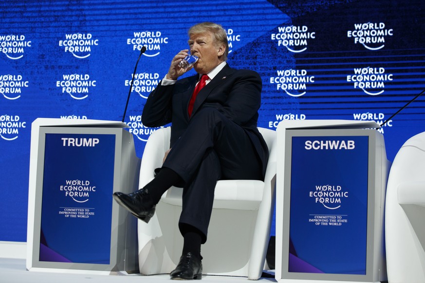 President Donald Trump drinks water before delivering a speech to the World Economic Forum, Friday, Jan. 26, 2018, in Davos. (AP Photo/Evan Vucci)