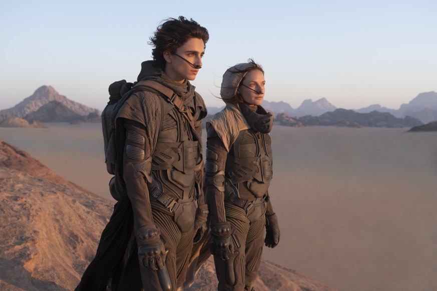 This image released by Warner Bros. Entertainment shows Timothee Chalamet, left, and Rebecca Ferguson in a scene from &quot;Dune.&quot; Warner Bros. said late Monday that its sci-fi pic