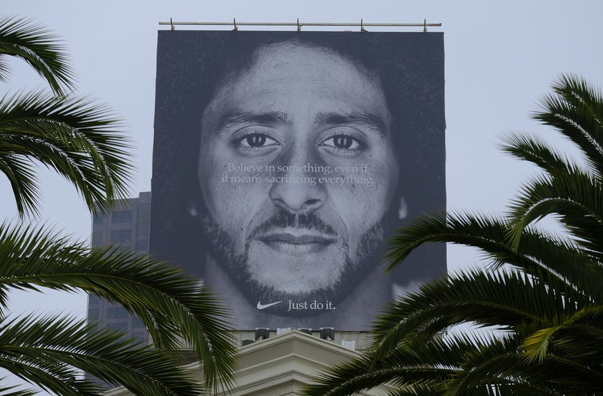 Palm trees frame a large billboard on top of a Nike store that shows former San Francisco 49ers quarterback Colin Kaepernick at Union Square, Wednesday, Sept. 5, 2018, in San Francisco. An endorsement ...