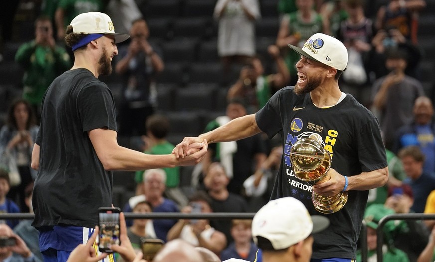 Golden State Warriors guard Stephen Curry, right and Golden State Warriors guard Klay Thompson celebrate after defeating the Boston Celtics in Game 6 to win basketball&#039;s NBA Finals, Thursday, Jun ...
