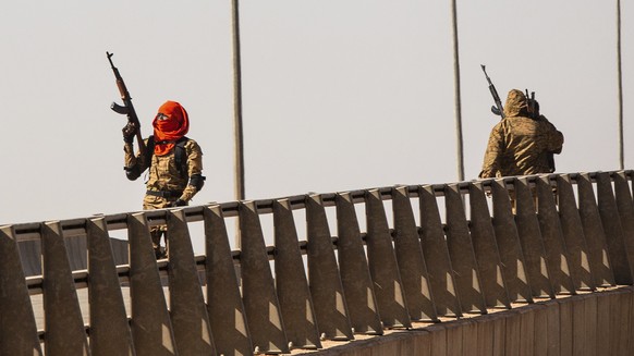 A mutinous soldier fires into the air at the Bobo interchange, near the Lamizana camp in Burkina Faso&#039;s capital Ouagadougou Sunday Jan. 23, 2022. Witnesses are reporting heavy gunfire at a milita ...