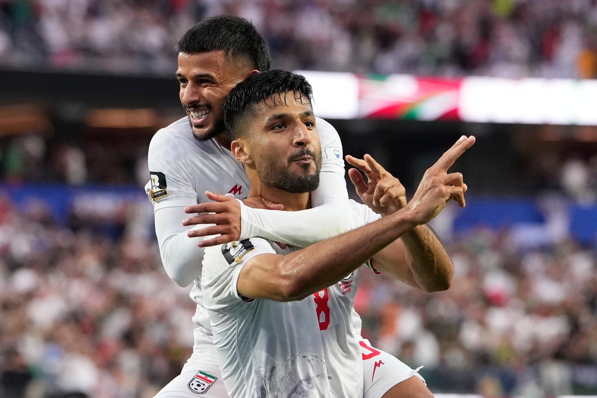 Iran's Mohammad Mohebbi (8) celebrates after scoring his side's second goal alongside Mehdi Ghayedi (10) during the World Cup Group G soccer match between Iran and New Zealand in Inglewood,  ...