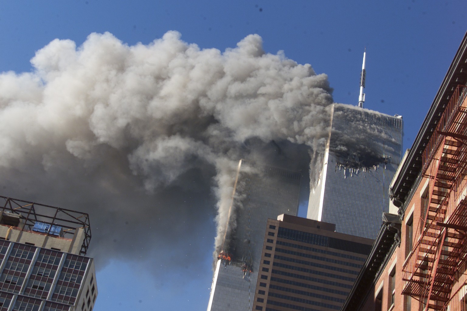 FILE - Smoke rises from the burning twin towers of the World Trade Center after hijacked planes crashed into the towers on September 11, 2001 in New York City. Associated Press photographer Richard Dr ...