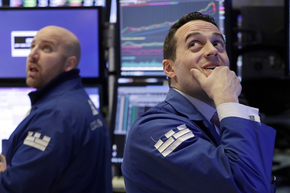 Specialists John Parisi, left, and Michael Gagliano work on the floor of the New York Stock Exchange, Monday, Feb. 5, 2018. The Dow Jones industrial average plunged more than 1,100 points Monday as st ...