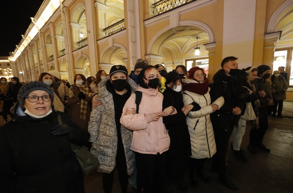 epa09794424 Russian protesters join hands and shout slogans during a rally against entry of Russian troops into Ukraine in St. Petersburg, Russia, 01 March 2022. Russian troops entered Ukraine on 24 F ...