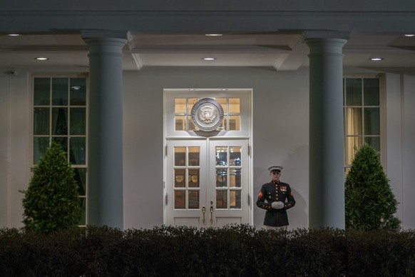 epa11277475 A Marine is posted outside the West Wing entrance of the White House, indicating that President Biden is present, in Washington, DC, USA, 13 April 2024. President Biden has returned to Was ...