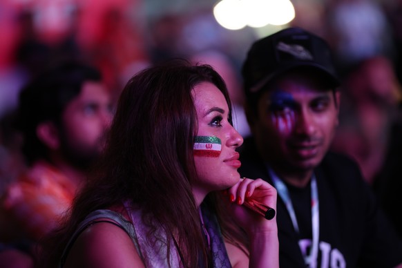 epa10337523 A fan of Iran watches the FIFA World Cup 2022 group B match between USA and Iran at Fan Festival, in Doha, Qatar, 29 November 2022. EPA/MARTIN DIVISEK