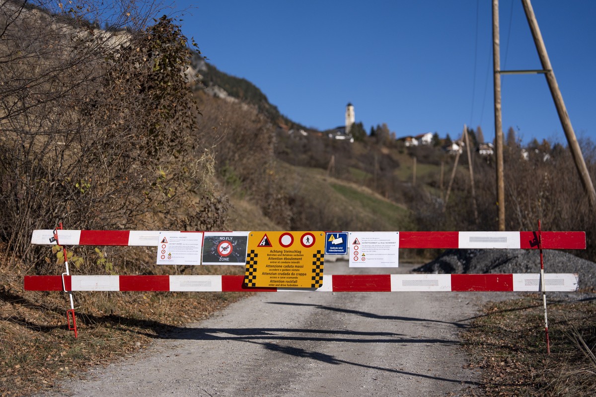 epa11725735 Signs and barriers block the road to Brienz Brinzauls, Switzerland, 17 November 2024. A stream of debris almost reached the village on 15 June 2024, which had been evacuated since 12 May 2 ...