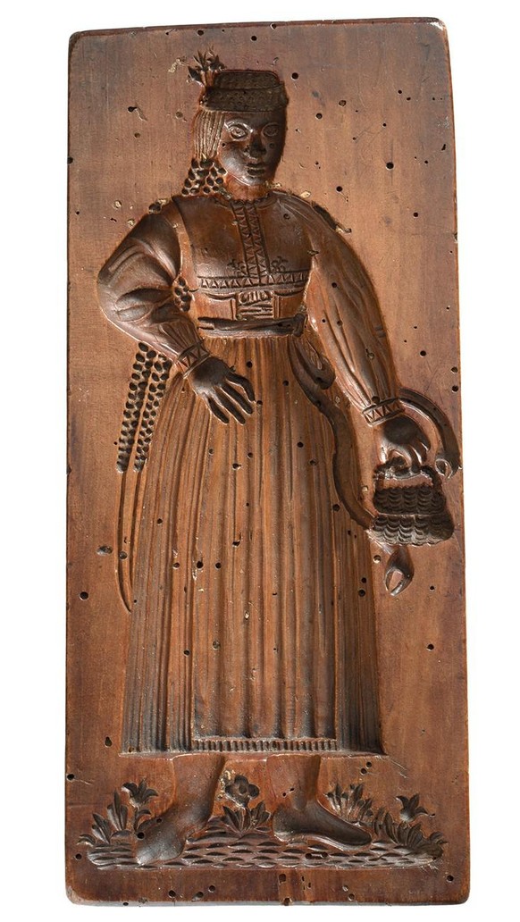 Frau mit Deckelkorb und langen Zöpfen. Gebäckmodel aus dem 17. Jahrhundert.