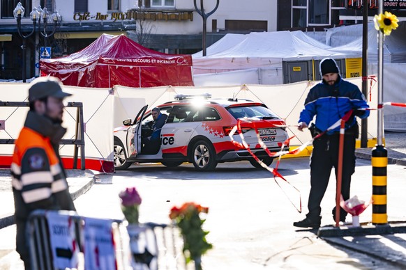 Police officers inspect the area where a unidentified origin fire broke out at the Le Constellation bar and lounge leaving people dead and injured, during New Years celebration, in Crans-Montana, Swi ...