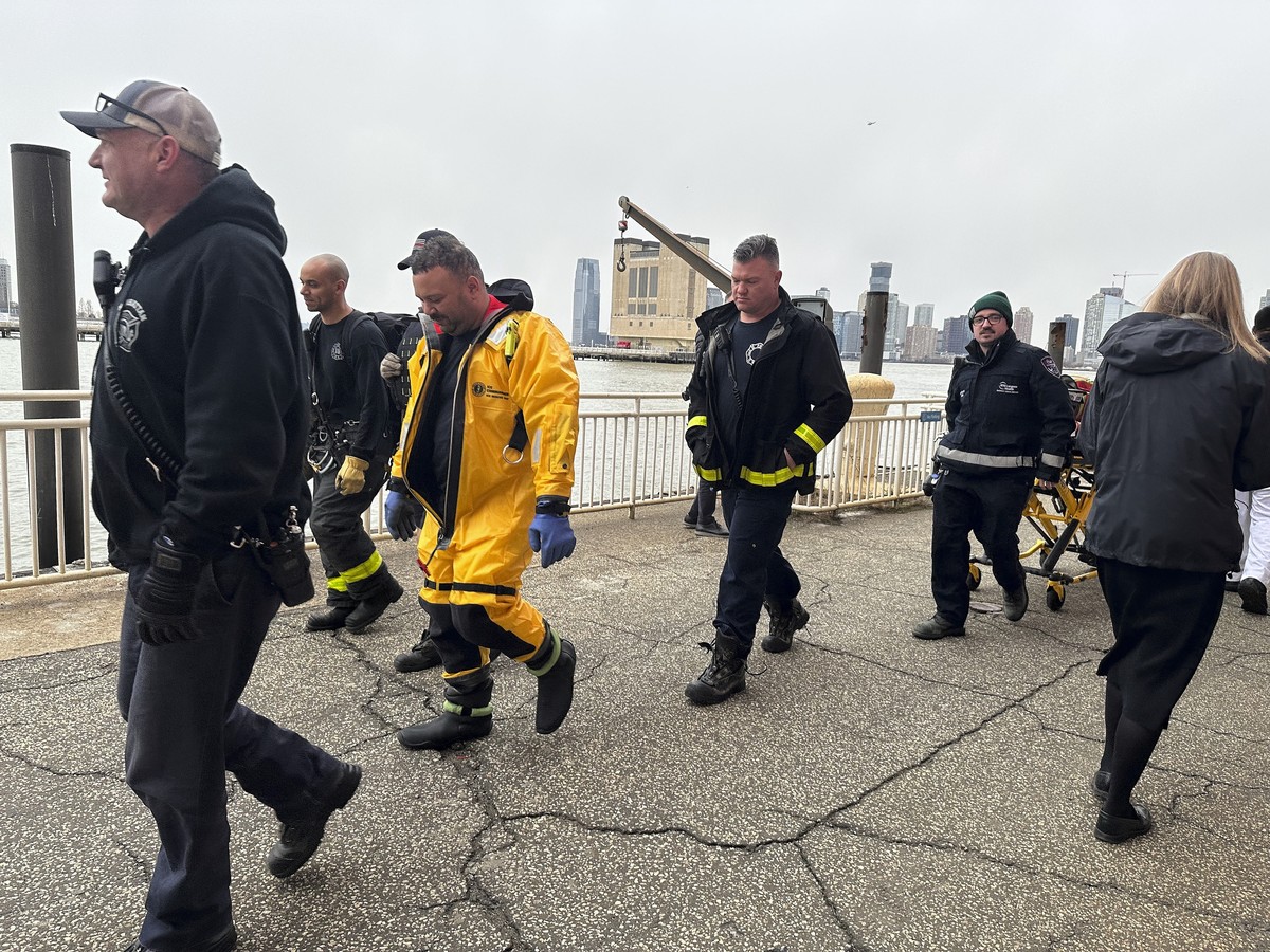 First responders walk along Pier 40, Thursday, April 10, 2025, in New York, across from where a helicopter went down in the Hudson River in Jersey City, N.J. (AP Photo/Jennifer Peltz)
NYC Helicopter C ...