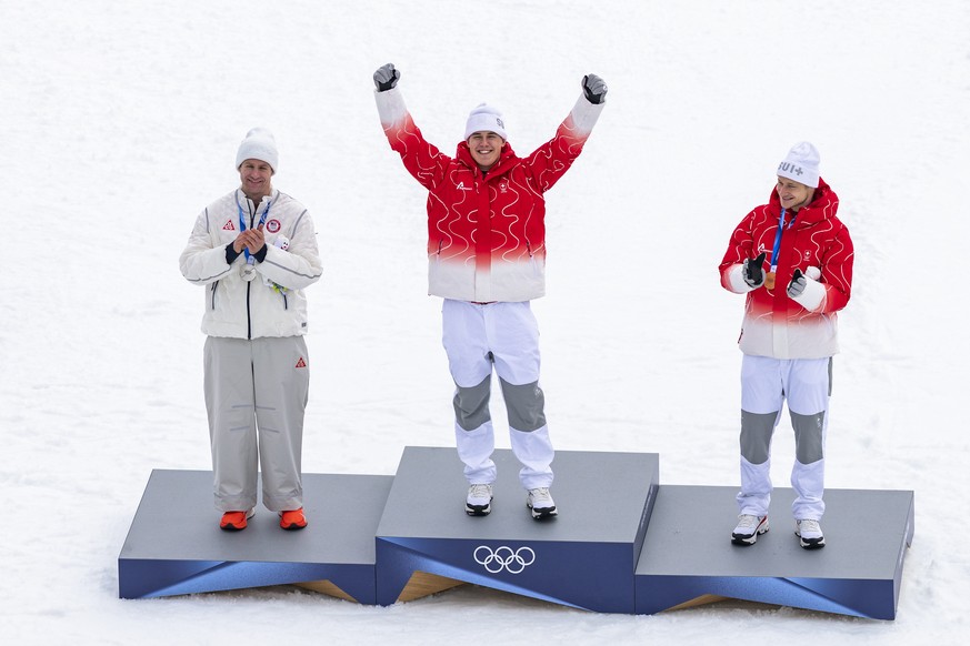Silver medalist Ryan Cochran Siegle of USA, gold medalist Franjo von Allmen of Switzerland, and bronze medalist Marco Odermatt of Switzerland, from left, pose on the podium after the men's alpine ...